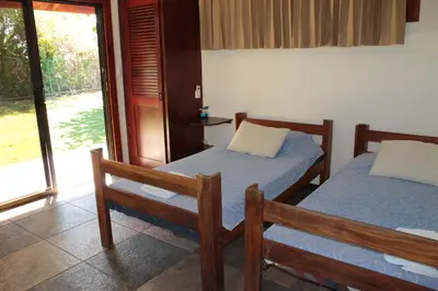 a bedroom with two beds and a door to a yard at Ocean View Echemare Tango Mar in Tambor