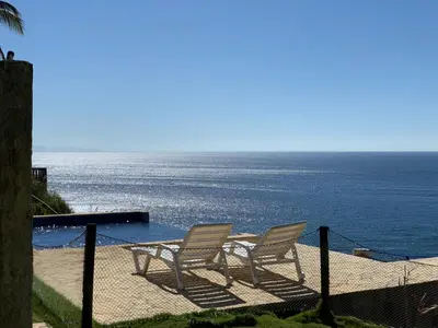 two chairs sitting next to a table and the ocean at Ocean View Echemare Tango Mar in Tambor