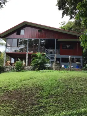 a red barn with glass windows and a yard at Jodokus Inn in Montezuma