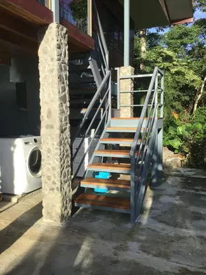 a set of stairs leading up to a house at Jodokus Inn in Montezuma