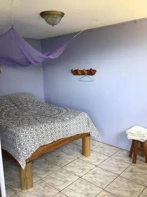 a bedroom with a bed and a shelf on the wall at Jodokus Inn in Montezuma