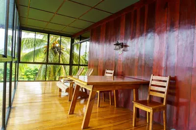 a dining room with a wooden table and chairs at Jodokus Inn in Montezuma