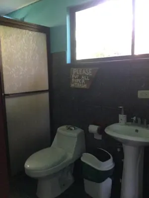a bathroom with a toilet and a sink at Jodokus Inn in Montezuma
