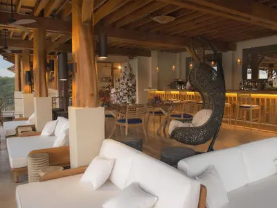 a living room with white furniture and a christmas tree at Casa Chameleon Hotel Las Catalinas - Adults Only in Playa Flamingo