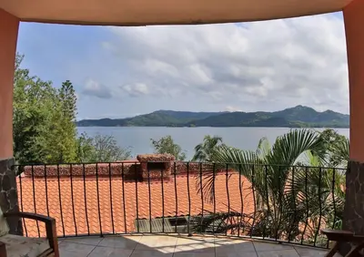 a view of a body of water from a balcony at Oceanview Studio Apartment with Community Pool & Views of Flamingo Marina in Playa Flamingo