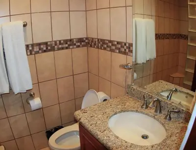 a bathroom with a sink and a toilet at Oceanview Studio Apartment with Community Pool & Views of Flamingo Marina in Playa Flamingo