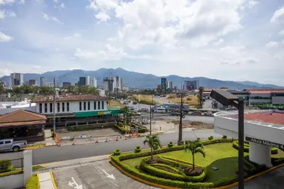 a view of a city with mountains in the background at Holiday Inn San Jose La Sabana by IHG in San José
