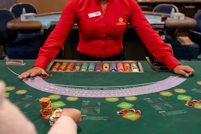 a woman standing in front of a table with donuts at Holiday Inn San Jose La Sabana by IHG in San José