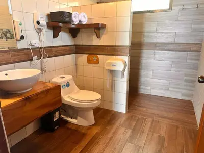 a bathroom with a toilet and a sink at Hotel Trópico Monteverde in Monteverde Costa Rica