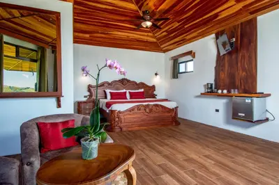 a bedroom with a bed and a wooden ceiling at Hotel Trópico Monteverde in Monteverde Costa Rica