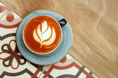 a cup of coffee sitting on a table at Paradise Hot Springs - Thermal Water & Volcano Views in Fortuna