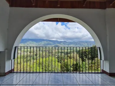 an archway in a building with a view of a mountain at Villas Valle Bello in Ujarrás