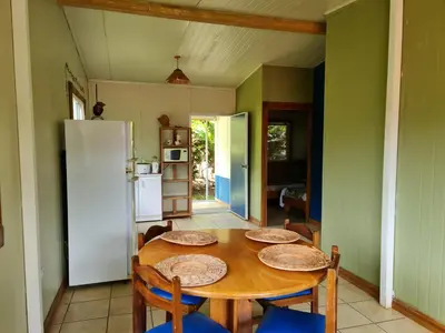 a kitchen with a table and chairs and a refrigerator at Villas Valle Bello in Ujarrás