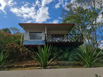 a house with a balcony on the side of it at Villas Valle Bello in Ujarrás