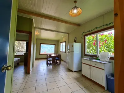 a kitchen with a refrigerator and a table with chairs at Villas Valle Bello in Ujarrás