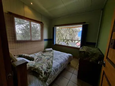 a small bedroom with a bed and a window at Villas Valle Bello in Ujarrás