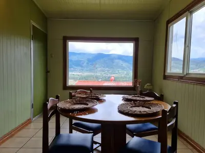 a room with a table with chairs and a window at Villas Valle Bello in Ujarrás