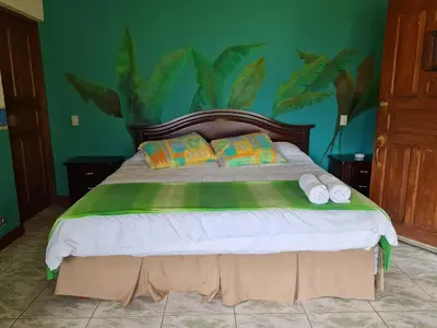 a bedroom with a large bed with two pillows at Villas Valle Bello in Ujarrás