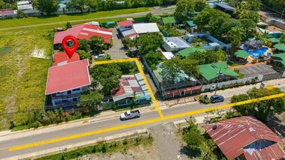 an overhead view of a city with a red marker at Cabinas Bahía Uvita - Marino Ballena National Park Lodge in Uvita
