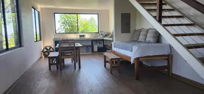 a bedroom with a bed and a desk in a room at Sunshine Sanctuary Boutique Jungle Lodge in Montezuma