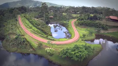 an aerial view of a road on an island in the water at La Anita Rain Forest in Colonia Dos Ríos