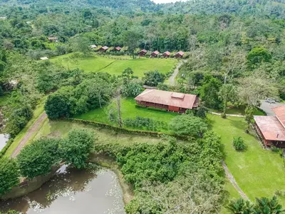 an aerial view of a house and a river at La Anita Rain Forest in Colonia Dos Ríos