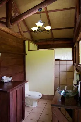 a bathroom with a toilet and a sink at La Anita Rain Forest in Colonia Dos Ríos