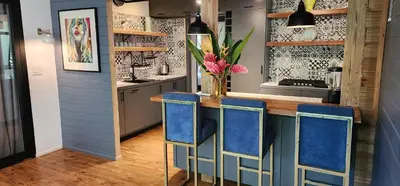 a kitchen with a blue island with blue chairs at Boutique Hotel y Spa Tangara Azul in Ojochal