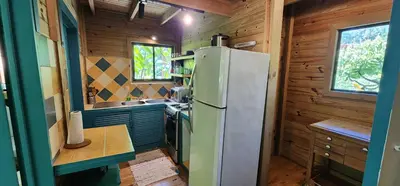 a kitchen with a refrigerator and a sink at Boutique Hotel y Spa Tangara Azul in Ojochal