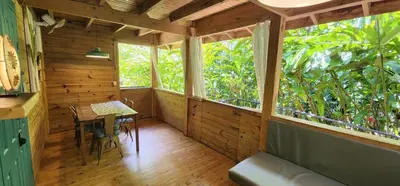 a wooden room with a table and a window at Boutique Hotel y Spa Tangara Azul in Ojochal