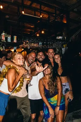 a group of people posing for a picture at a party at ESO Santa Teresa in Santa Teresa Beach