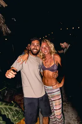 a man and woman posing for a picture at a party at ESO Santa Teresa in Santa Teresa Beach