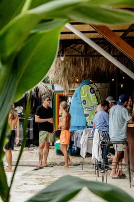 a group of people standing on the beach at ESO Santa Teresa in Santa Teresa Beach