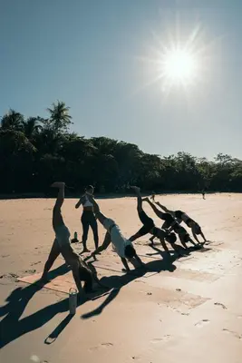 a group of people running on the beach at ESO Santa Teresa in Santa Teresa Beach
