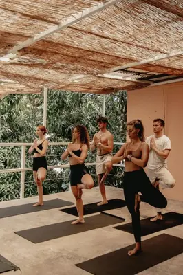 a group of people doing yoga in a room at Armonia Santa Teresa in Santa Teresa Beach