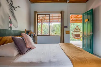 a bedroom with a large bed and a window at Armonia Santa Teresa in Santa Teresa Beach