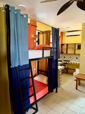a couple of bunk beds in a room at Sandy Toes Hostel in Sámara
