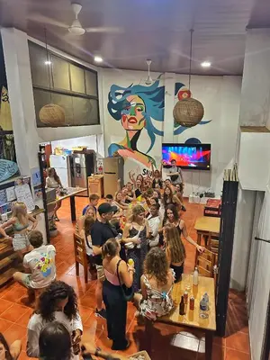 a group of children in a hair salon at Sandy Toes Hostel in Sámara