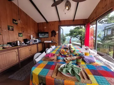 a kitchen with a table with food on it at Reventazon River Mountain Ranch in Turrialba