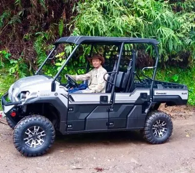 a man sitting in a toyota utility vehicle at Reventazon River Mountain Ranch in Turrialba