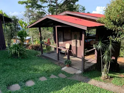 a small shed with a bench in a yard at Reventazon River Mountain Ranch in Turrialba