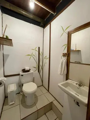 a bathroom with a toilet and a sink at Beach Cabinas in Santa Teresa Beach