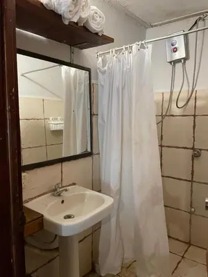 a bathroom with a sink and a shower curtain at Beach Cabinas in Santa Teresa Beach