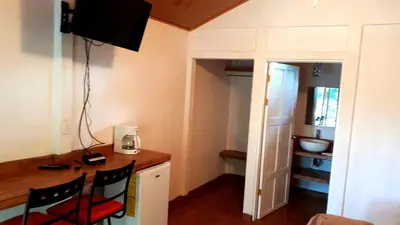 a room with a desk and two chairs in a room at Tropical Paradise Bungalows in Pital
