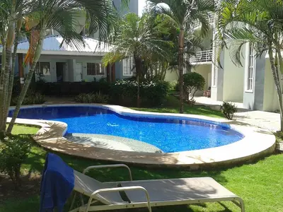 a swimming pool in the yard of a house at Pura Vida Condo in Tamarindo