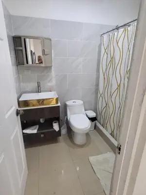 a bathroom with a toilet and a sink at Pura Vida Condo in Tamarindo