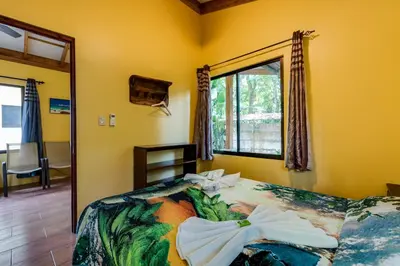 a bedroom with a bed with a bow on it at Tropical Beach in Uvita