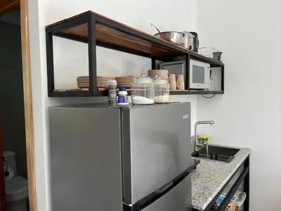 a shelf above a refrigerator in a kitchen at La Jungla in Carrillo