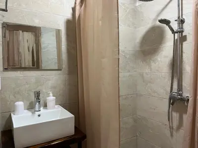 a bathroom with a sink and a shower at La Jungla in Carrillo