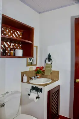 a bathroom with a sink and a toilet at Hotel Hacienda del Mar in Carrillo